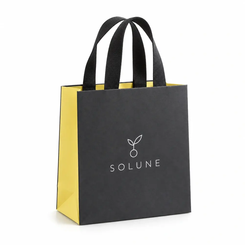 charcoal with lemon yellow accents ribbon-handle gift bags with SOLUNE logo printing on a white background