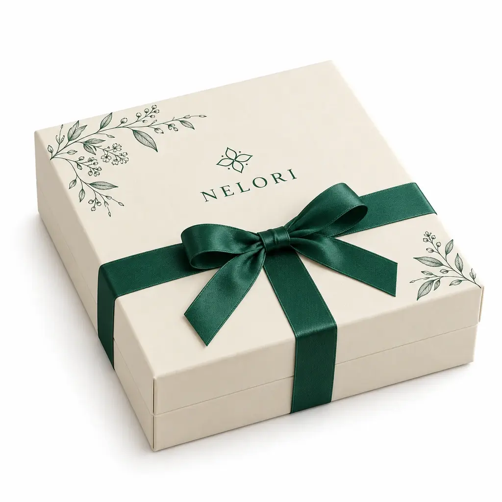 warm ivory and emerald ribbon-accented square magnetic keepsake box with NELORI logo printing on a white background