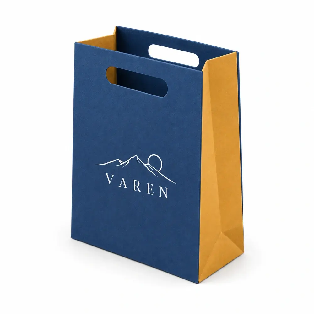 Alternate view of the denim blue with ochre accents die-cut handle bags with VAREN artwork