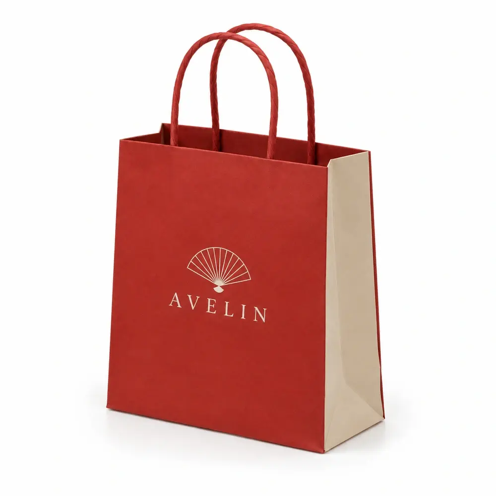 Alternate view of the brick red with sand accents twisted-paper handle bags with AVELIN artwork